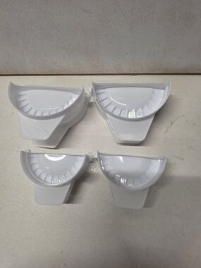 Set of 4 white plastic dumpling/empanada presses in two different sizes.